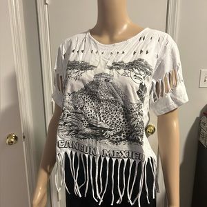 Cancun Mexico white cut up short sleeve top with fringes.